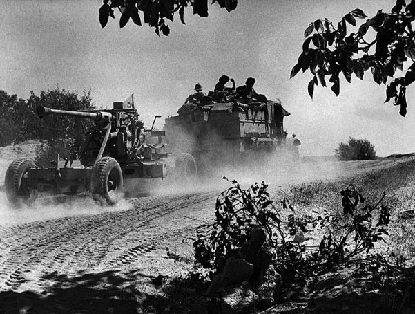 A British truck pulls an antiaircraft gun across a duty track in Syria