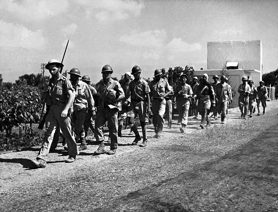 Vichy soldiers are marched into captivity after the surrender of Syria